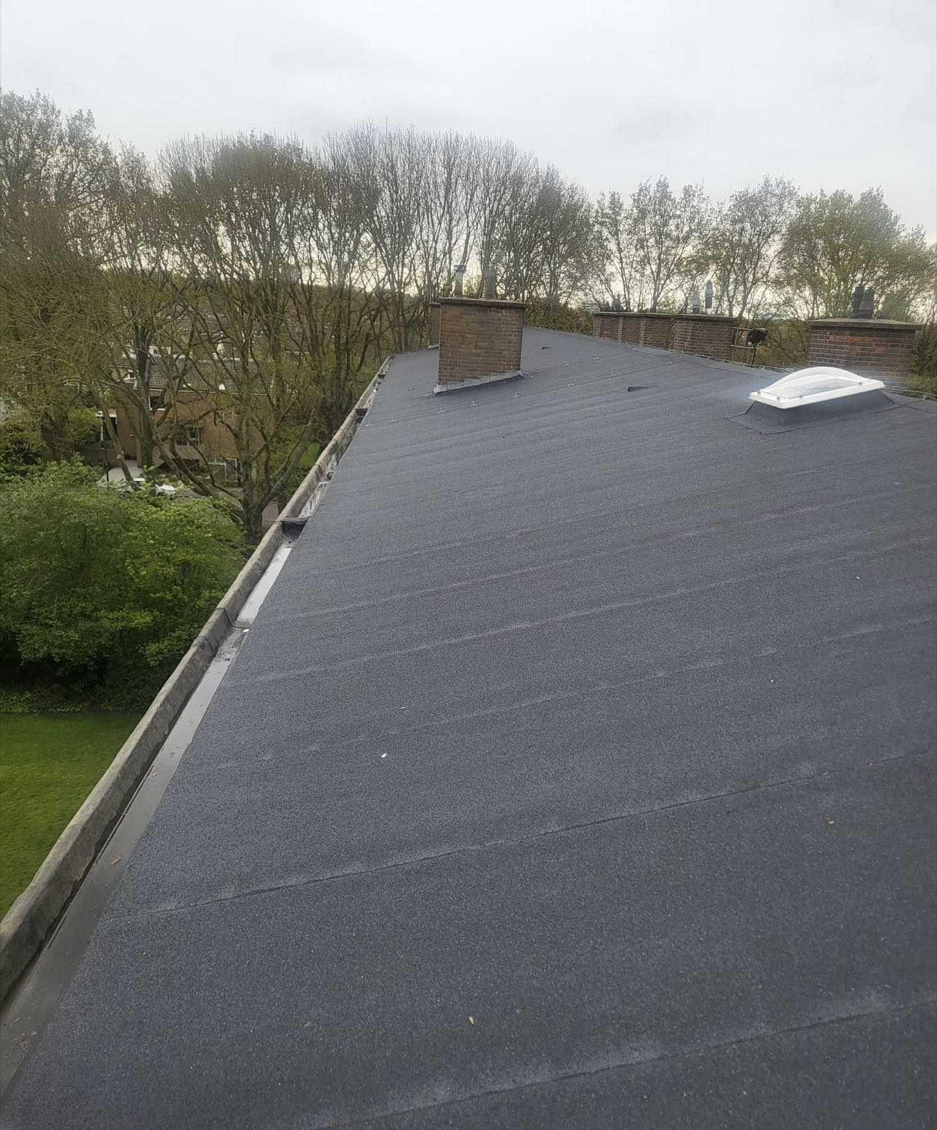 Plat dak met schoorstenen en een lichtkoepel